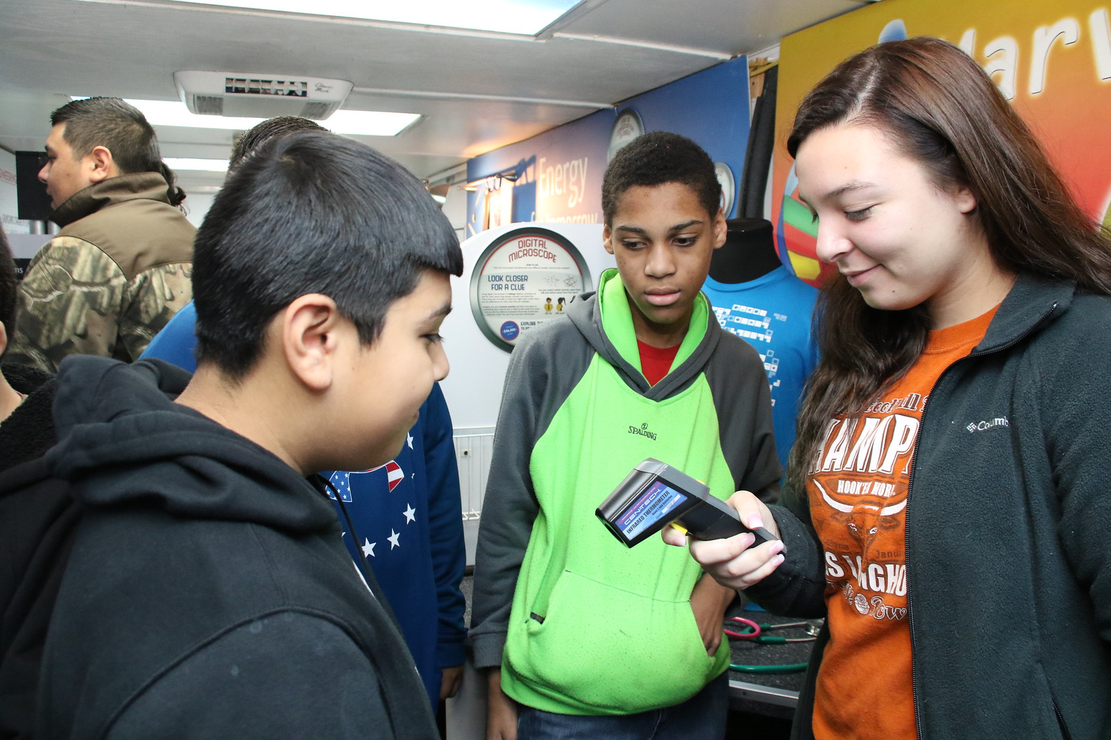 
Emily Alfaro, a senior and future teacher from Goose Creek Memorial High School, shows Horace Mann Junior sixth-graders (from left) Alexes Diaz and Gerald Barksdale how to use a digital thermometer during a visit to the Texas Alliance for Minorities in Engineering (TAME) Trailblazer trailer. Sponsored by Chevron Phillips Chemical Company LP, the trailer provides science, technology, engineering and math (STEM) activities for students.
