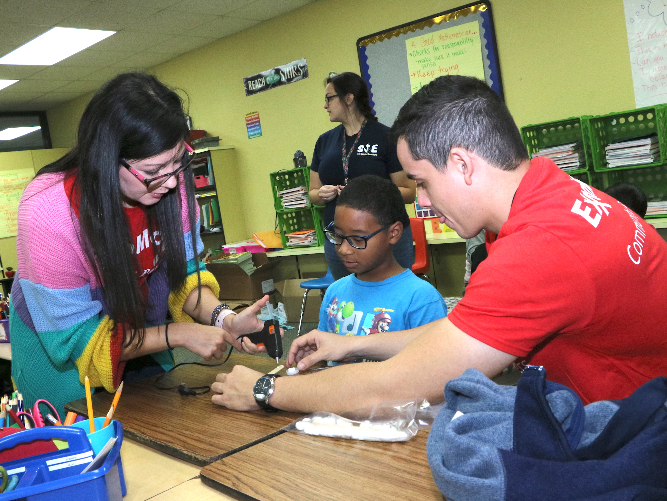 
Susana Munoz (left), ExxonMobil Partners In Education representative and former San Jacinto Elementary student, works with San Jacinto Elementary student Chaz Caldwell (middle) and Angel Santiago from ExxonMobil to build a catapult, one of the STEM activities provided by ExxonMobil’s Global Organization for the Advancement of Latinos (GOAL).
