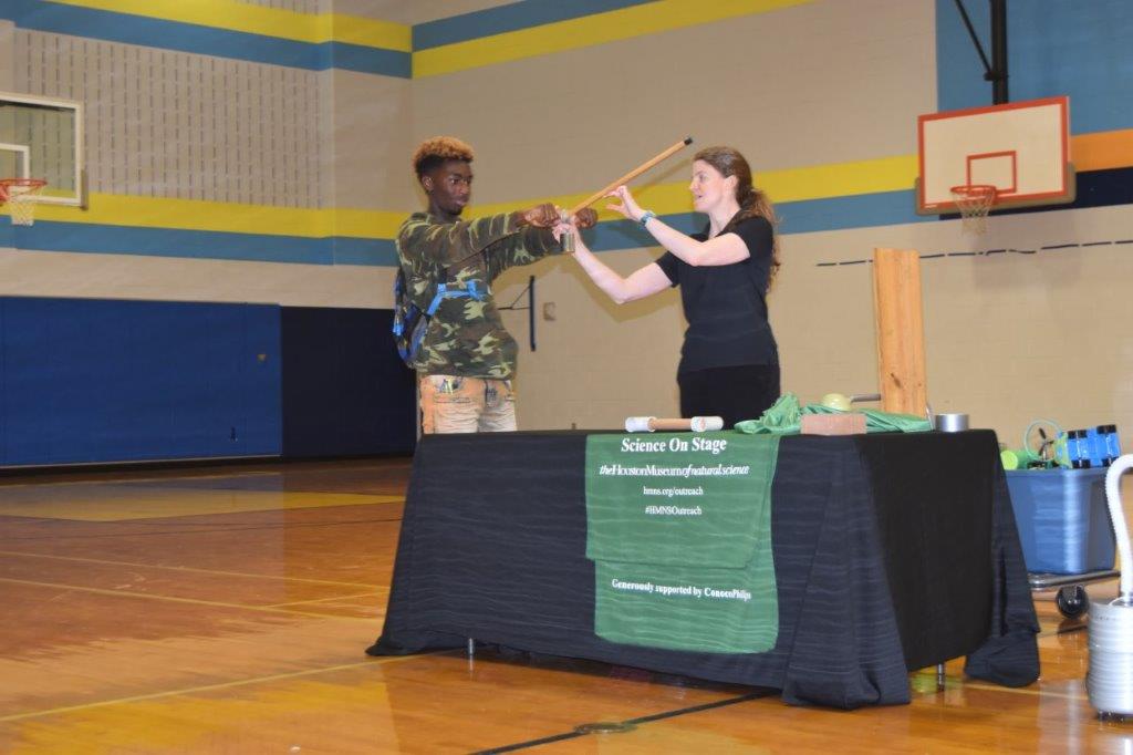 
Irmante Givens (left) helps the presenter from the Houston Museum of Natural Science Mobile Field Trip with a Motion and Commotion activity at Cedar Bayou Junior School. The presentation coordinated with the Force and Motion Unit in Science.
