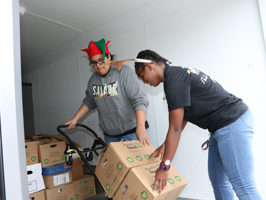 
Ross S. Sterling PALs Anthony Alanis (left) and Keyma Stevenson load food donations into a truck bound for the Houston Food Bank during the annual Channel 13 Share Your Holidays Food Drive in Baytown.
