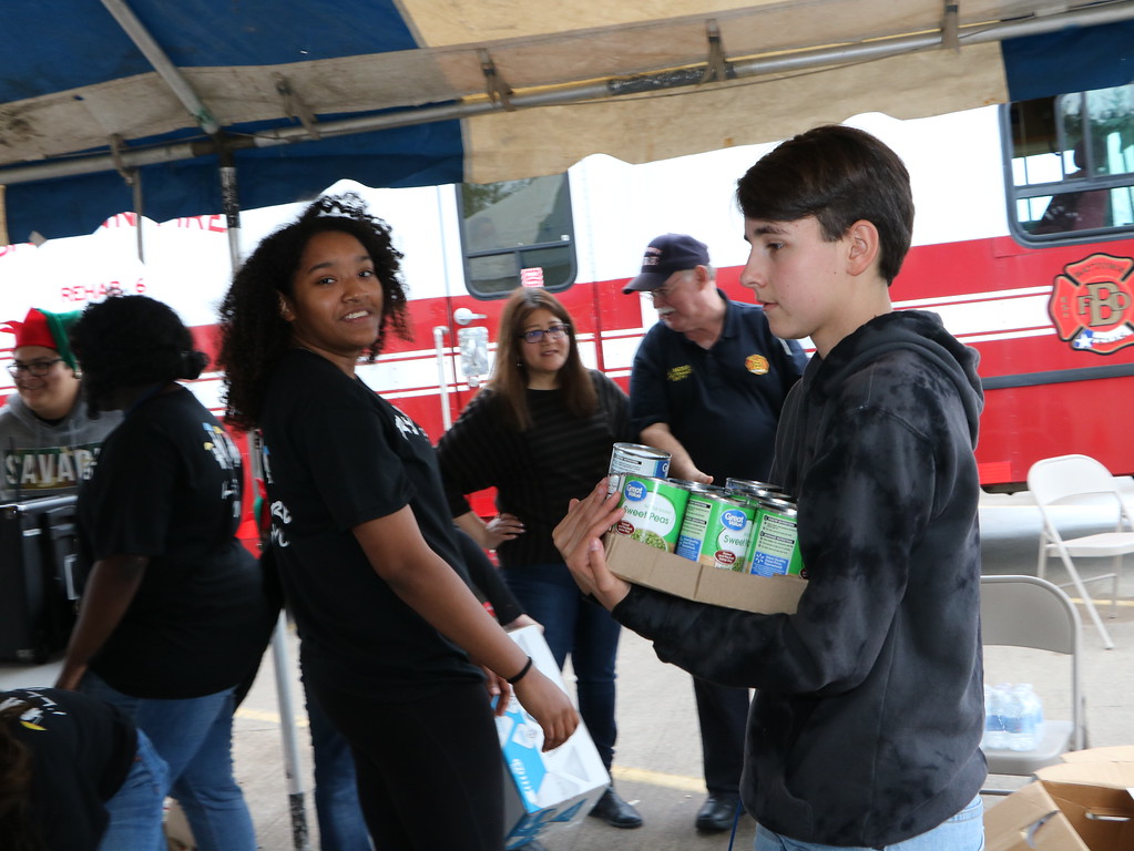 
Jazmine Morris (left) and Theresa Vargo (right), Ross S. Sterling High School PALs,  help stack donations from the community for Channel 13’s Share Your Holidays Food Drive to benefit the Houston Food Bank.
