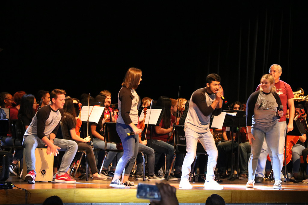 
Choir members from Goose Creek CISD high schools rap at the recent convocations during the opening musical number, “One Hundred Years of Class,” lyrics and music by Phillip Morgan and transcribed by Kevin Coward and Michael Grauvogl.
Band, orchestra, choir, drill team and theatre students along with their directors from Goose Creek Memorial, Ross S. Sterling and Robert E. Lee high schools combined to kick off the 100th anniversary of Goose Creek CISD.
