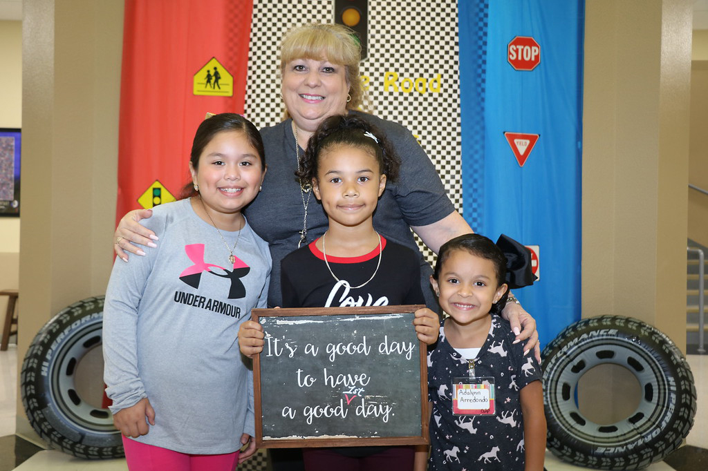 
Katherine Cruz (in back), new principal at Ashbel Smith Elementary, and (from left) Nayeli Sierra, third grade; Nevaeh Garcia, fourth grade; and Adalynn Arredondo, kindergarten, plan to have a good first day of school.
