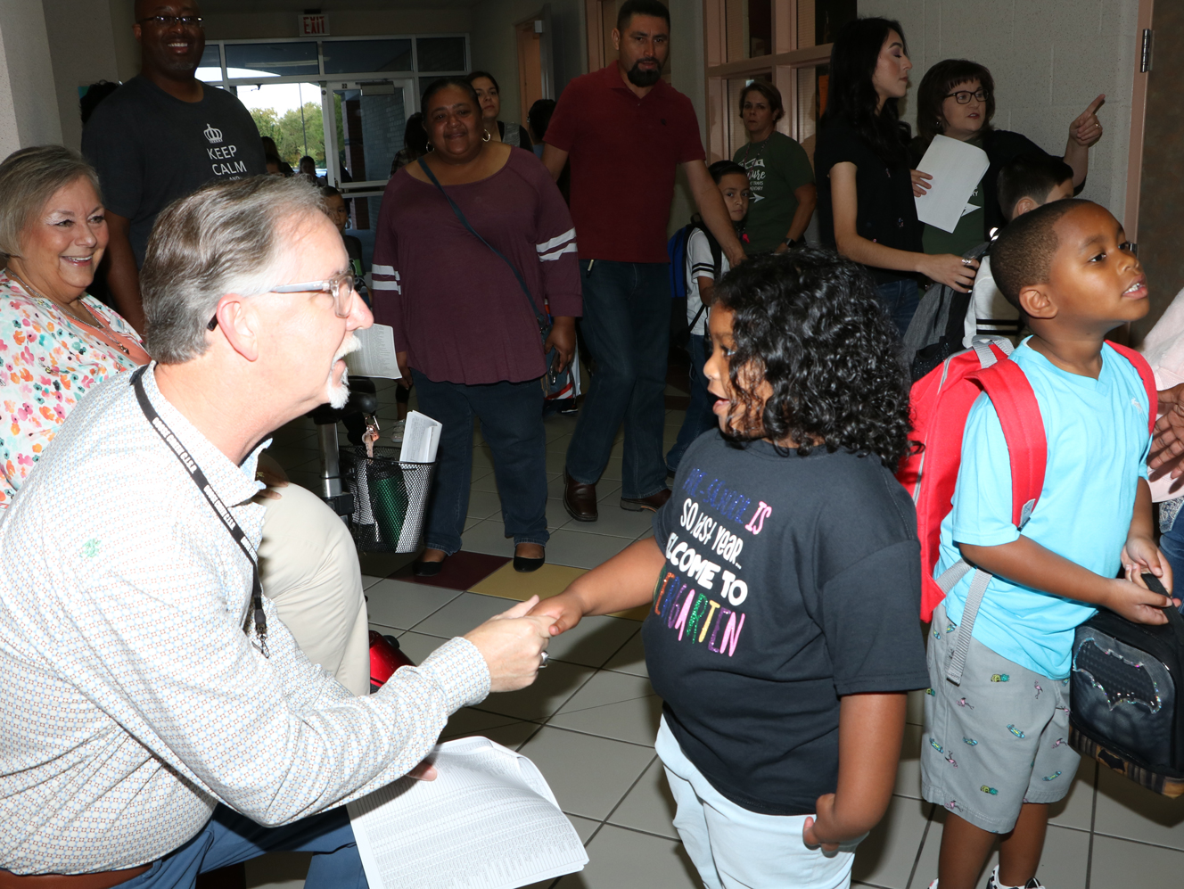 
Richard Clem, Goose Creek CISD Board member, greets Maliah Poullard, kindergartner, on her first day of school at Travis Elementary.

