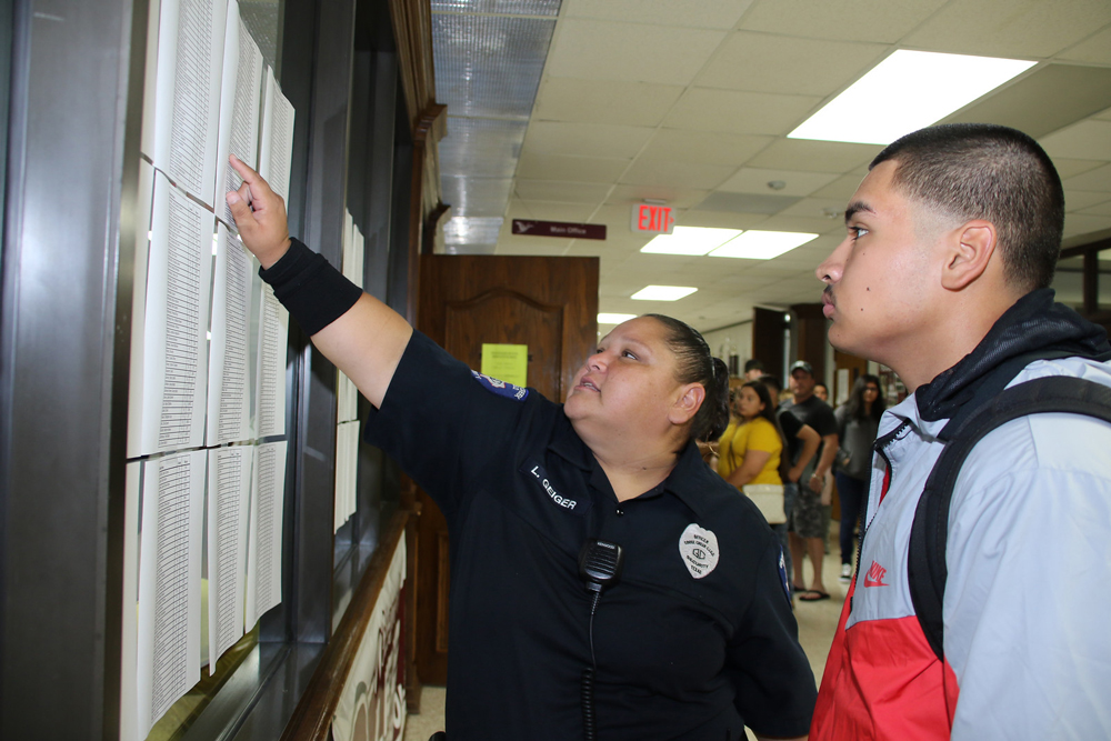 
Lisa Geiger (left), security officer at Robert E. Lee High School, helps Luis Munguia find his homeroom.
