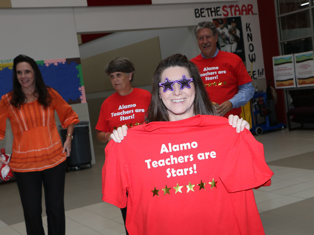 
Andrea Zepeda (front), principal of Alamo Elementary, shows off her new shirt and glasses as her students and faculty are recognized by Goose Creek CISD administrators for earning six Distinctions on the STAAR. Alamo received Distinctions for Academic Achievement in  ELA, Math and Science; Top 25 Percent Comparative Academic Growth; Top 25 Percent Comparative Closing the Gaps and Postsecondary Readiness. Pictured are (from left) Dr. Melissa Duarte, deputy superintendent for curriculum and instruction; Becky Robins, director of curriculum and instruction and Randal O’Brien, GCCISD superintendent.
