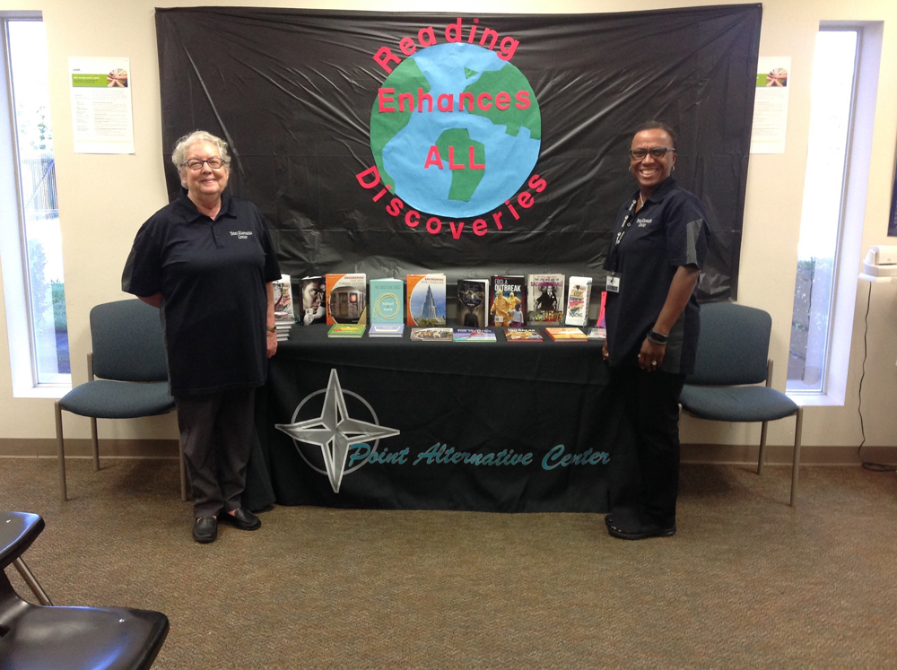 
Rachel Prettyman and Teresa Jones display books available to students at POINT Alternative Center to allow them to experience the joy of reading.
