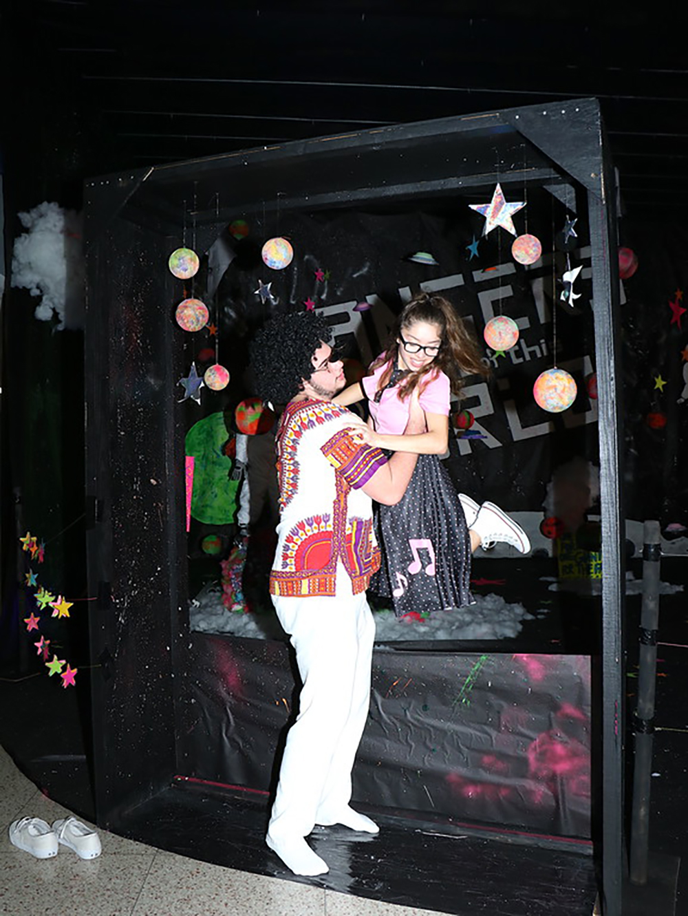 
Juniors Jacob Hotchkiss (left) helps Brittany Topete out of the homecoming display, “Rangers Are Out of This World,” as the Ross S. Sterling High School Rangers celebrate Decades Day in honor of the homecoming game against Channelview High School Friday at Stallworth Stadium.
Sterling students and staff created the fantastic display, including a spaceship, an astronaut, planets and stars, in the RSS Commons.
