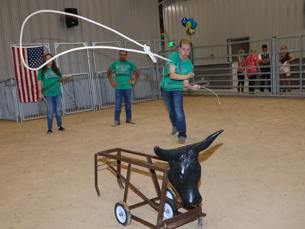 
Terry Swindoll, a student from Stuart Career Tech High School, tries his hand at roping during the grand opening of Goose Creek CISD’s Agriscience Center. The facility, which will be used by FFA students from Goose Creek Memorial,. Robert E. Lee, Ross S. Sterling and Stuart Career Tech high schools, includes two classrooms, a practice arena, student locker rooms, large equipment storage areas and separate animal barns with wash, groom and feed areas. Former councilman Terry Sain spoke to students about pride, and Kevin Parker, former Goose Creek CISD CTE director, provided information about the many certifications students can earn in Agriculture Science classes.
