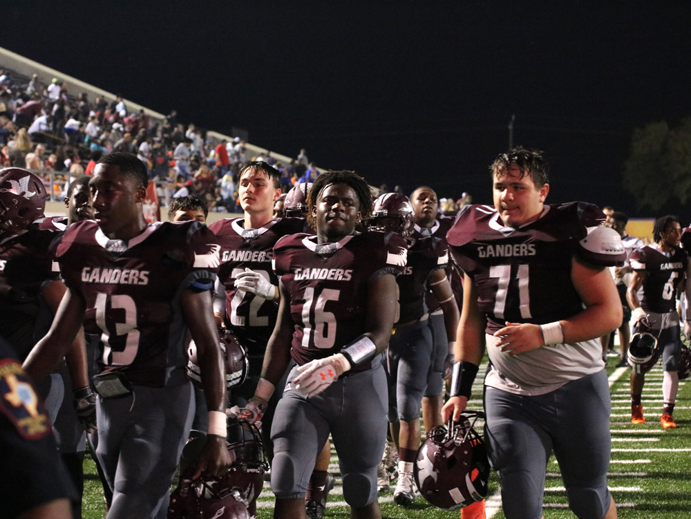 
Billy Haynes (71), heads into the locker room with his teammates during halftime of a recent game. Despite not being able to wear his hearing aid during the games, he gets his job done, relying on help from an interpreter as well as cues from his coaches.
