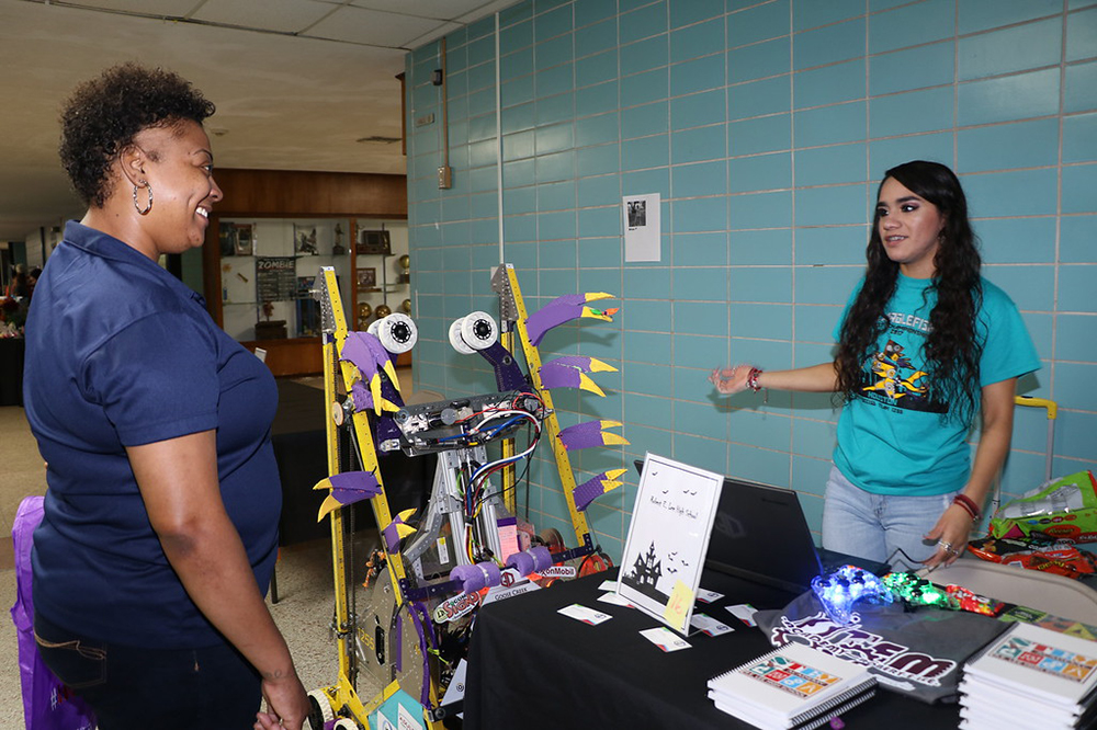 
Ixzel Amador (right), a member of the Blarglefish Robotics Team from Ross S. Sterling High School, shows Renae Lewis how the robot works at Goose Creek CISD’s Parent Resource Fair.
