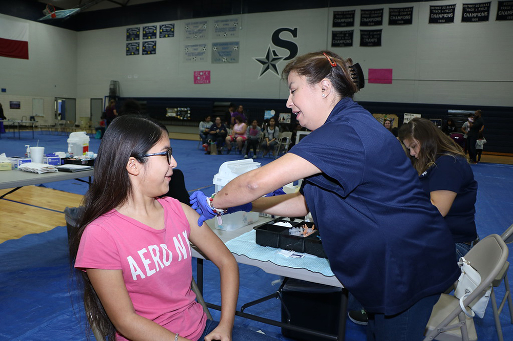 
The Parent Resource Fair at Ross S. Sterling High School was a good place for Andrea Rivera, a seventh-grader at Highlands Junior School, to get her free flu shot from Herminia Caras, medical assistant at Harris Health System.
