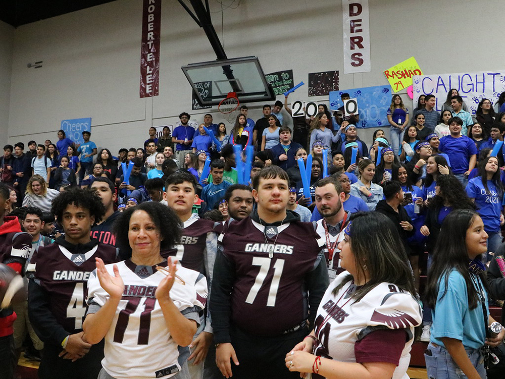 
REL teachers and football players enjoy the 90th Anniversary pep rally.
