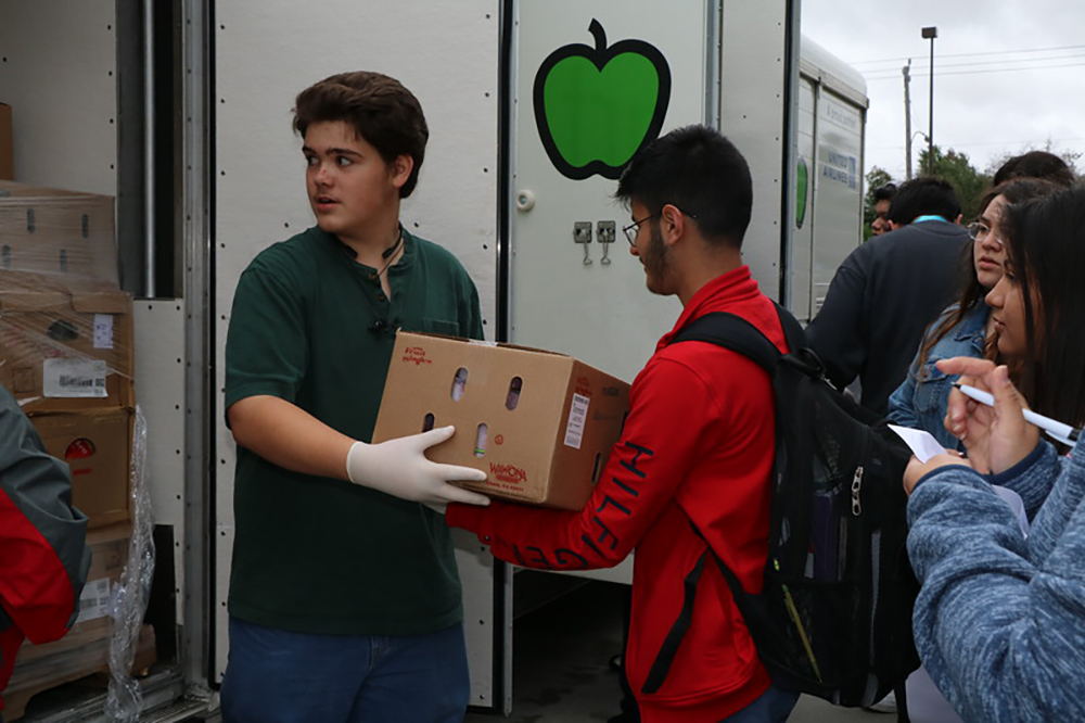 
David Isaacks (left) and Daniel Lucatero, both sophomores at IMPACT, help unload the Houston Food Bank truck for the Spartan Market. The goal of the Spartan Market is to provide healthy and fresh food for the Baytown area community.
