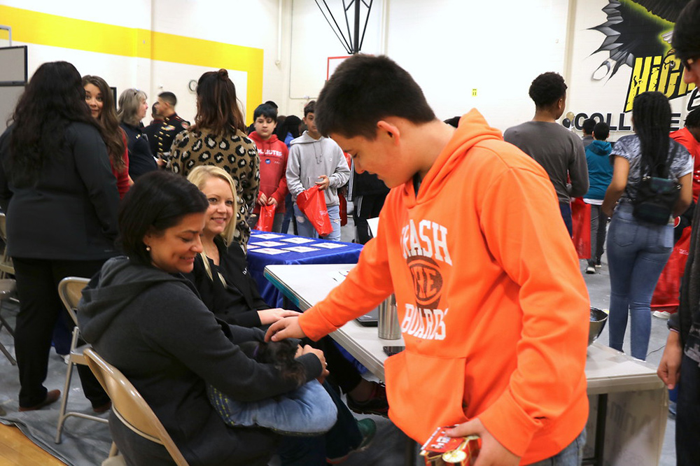 
Clayton Fullbright, an eighth-grader at Highlands Junior School, visits with Bobbie, a toy schnauzer, and (from left) Kristian Foreman and Dr. Amy Chou from Abshier-Meuth Animal Hospital at the Third Annual College and Career Fair. The event helps students match colleges and career to the different endorsements they will choose among in the next few weeks.
