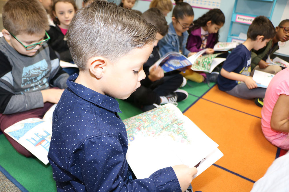 
Jacob Orosco, a first-grader in Jennifer Starr’s class at Dr. Antonio Bañuelos Elementary, reads his new book “If You Take a Mouse to the Movies” by Laura Joffe Numeroff, presented to all first-graders in Goose Creek CISD, Barbers Hill ISD and private schools Baytown Christian Academy, St. Joseph Catholic School and First Baptist Academy, by Gamma Nu and Epsilon Psi, chapters of the Delta Kappa Gamma Society International, an organization for women educators. To make a donation for the “A Storybook Christmas” project, please call Carolyn Francis at 281-427-5930.
