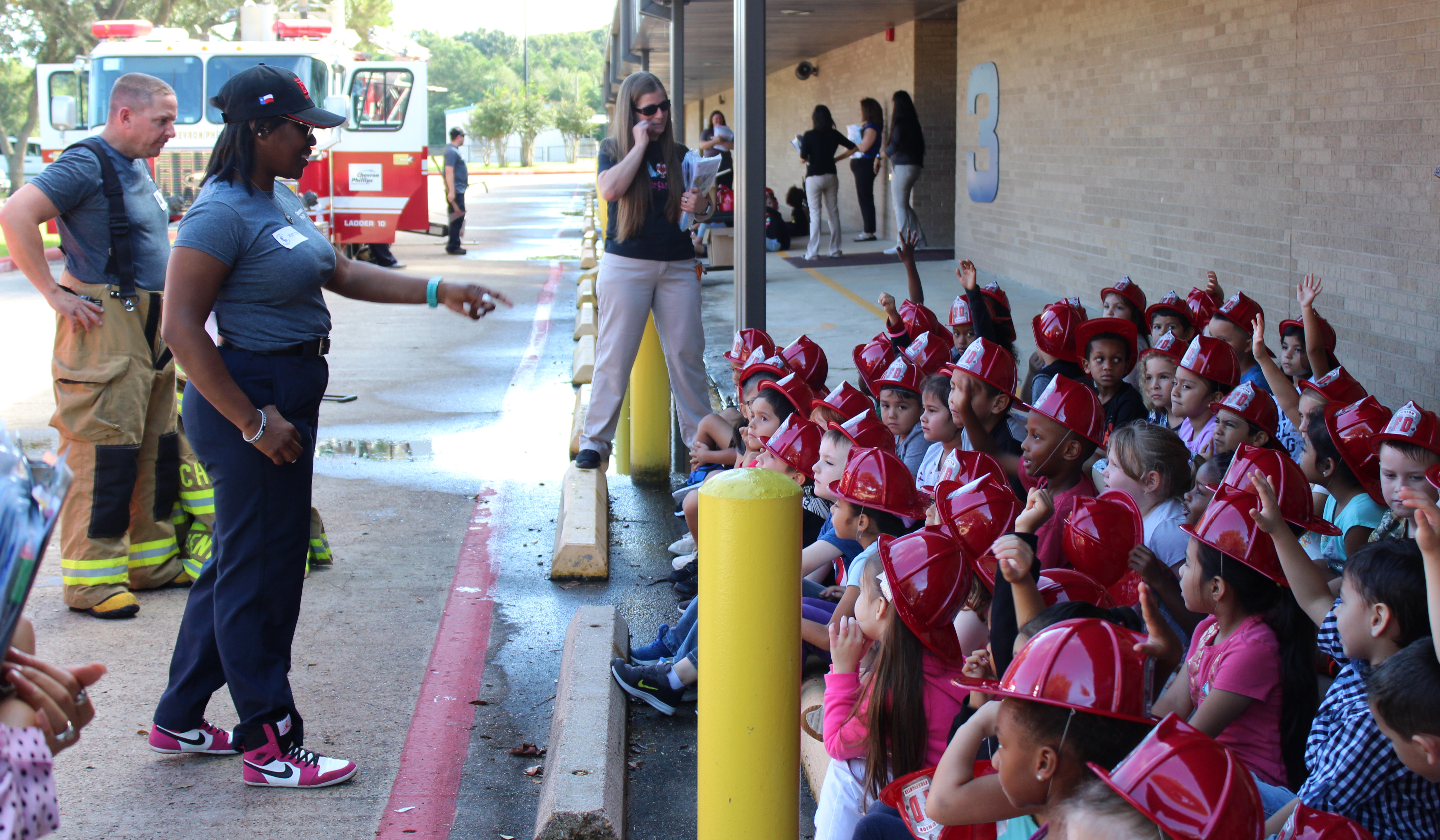 
Yanique Messitho and Nick Wilks, both process operators and volunteer emergency response team members for Chevron Phillips Chemical, teach a class of kindergartners at Crockett Elementary the importance of fire safety during Fire Prevention Week.
