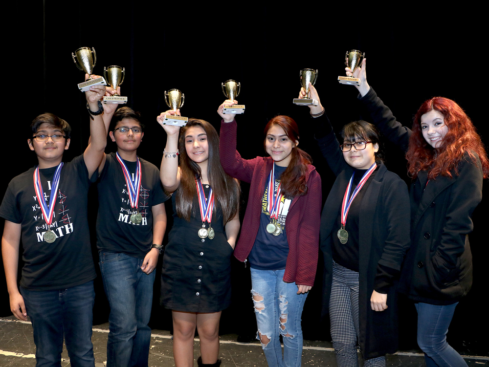 6 students hold trophies.
