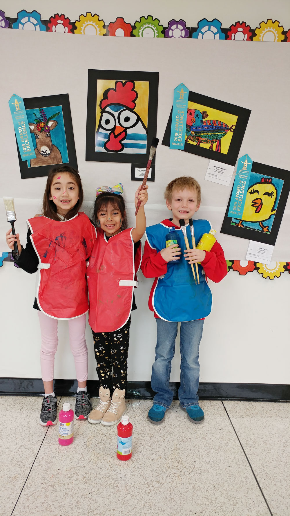 
Four students pose with their artwork
