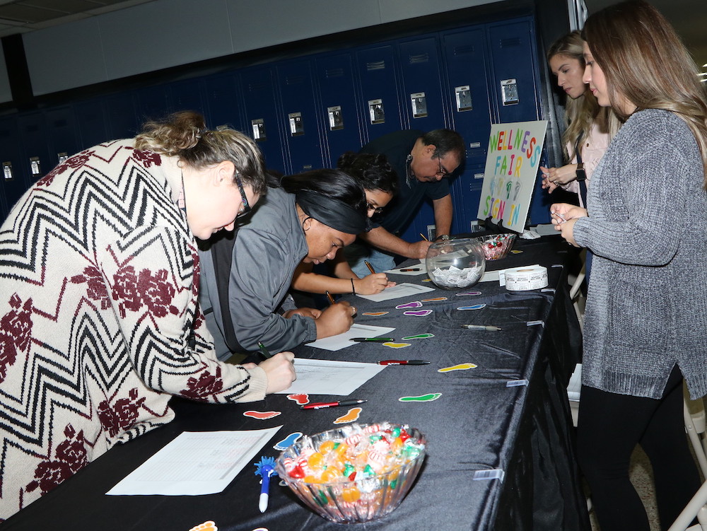 
Goose Creek CISD employees (from left) Misty Stephens, Myleka King and Regina Aguilar from Carver Elementary and J. Carlos Alvarez from Cedar Bayou Junior School register for the Goose Creek CISD 2nd Annual Employee Wellness Fair at Ross S. Sterling High School with Letty Arredondo (back right) and Maria Andrade from Human Resources.
