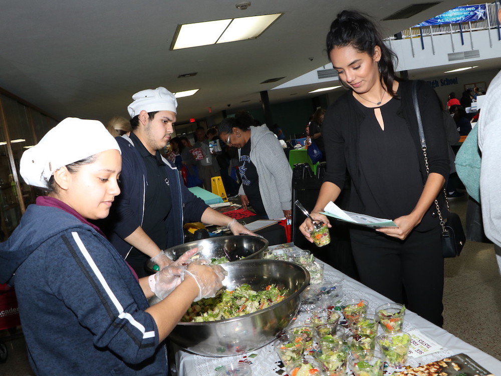 
Stacy Fernandez (right) from the Goose Creek CISD Communications Department samples a salad from Salata served by employees Daniela Gualito (left) and Sebastian Benavides at the recent Goose Creek CISD 2nd Annual Employee Wellness Fair held at Ross S. Sterling High School.
