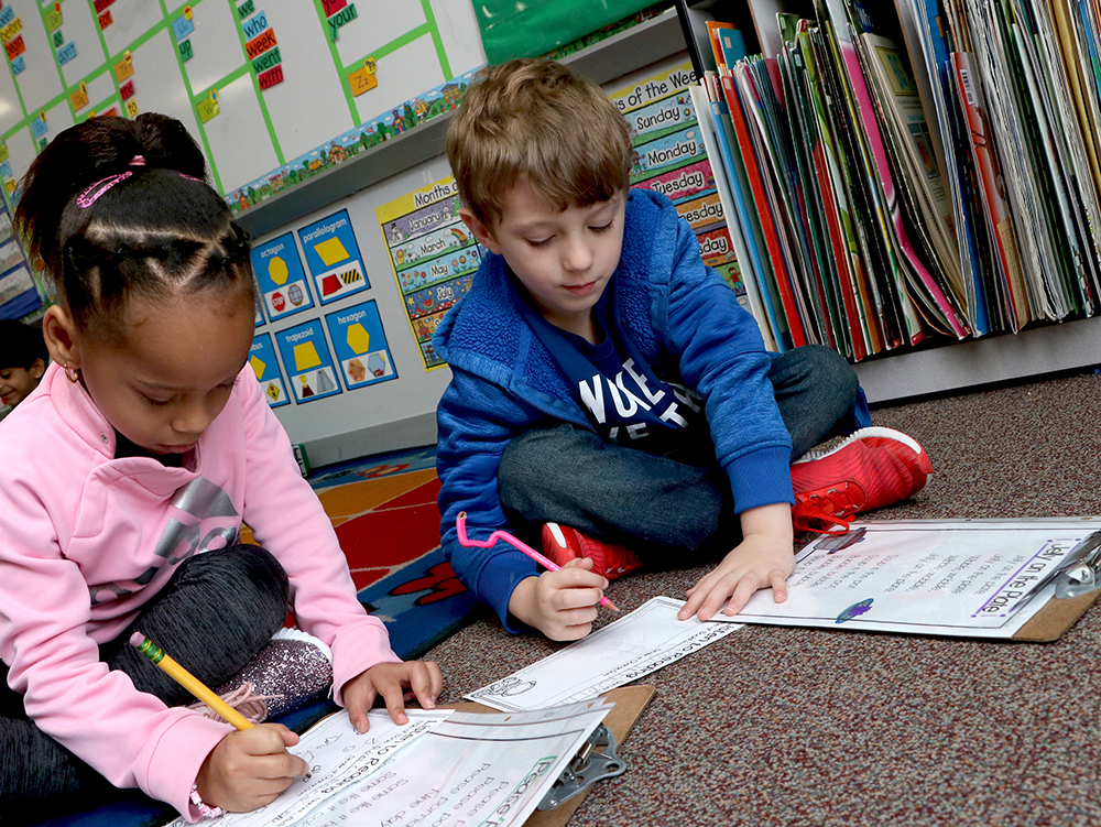 
Victoria Walker Elementary first-graders Amaya Richards-Wynn (left) and Emmett Cleveland work on poetry on their first day back to school after the Christmas holidays.

