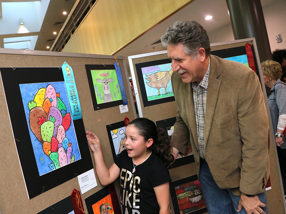 
Emily Sistos, a third-grader from James Bowie Elementary, shows off her Rodeo Art to Dr. Randal O’Brien, superintendent of schools.
