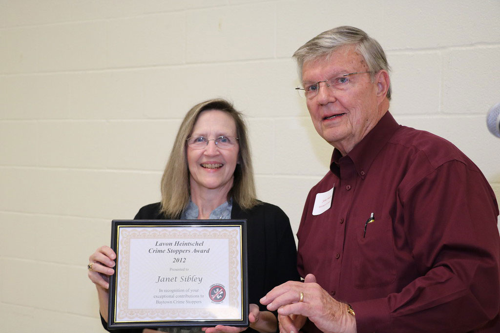 
Janet Sibley (left), a Baytown Crime Stoppers Board member for 29 years, is presented with a certificate recognizing her as the first Lavon F. Heintschel Award winner in 2012, by John Mabry, chair of the History/Records/Recognition Committee.
