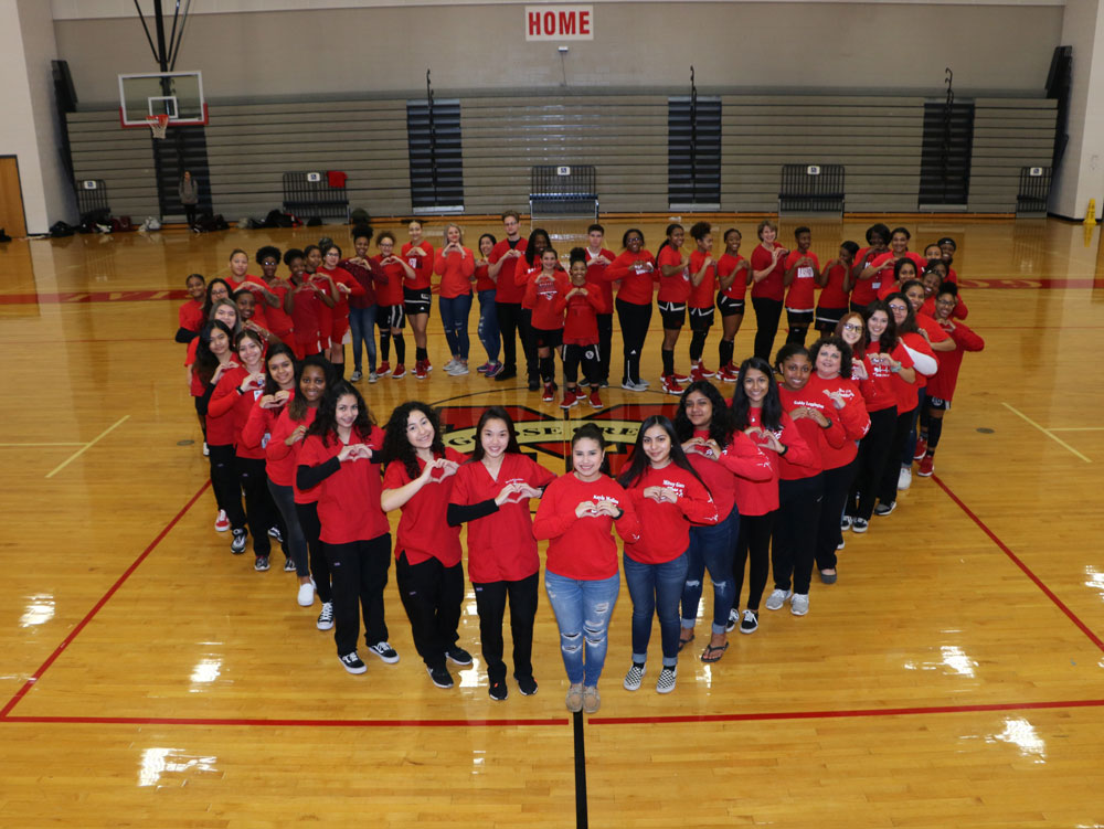 
Students form heart shape at gym.
