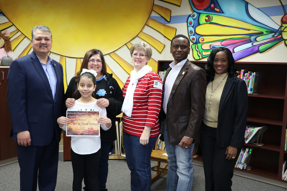 
Jannel Cruz (front), third grade, shows off the certificate for four Pirates Bay Tickets she received in a drawing at Bowie Elementary for reading 10 or more books for the Mayor’s Winter Break Challenge through the Renaissance myON Reader program. The individualized reading program was made possible through a grant from Covestro, the school’s Partner In Education.  Pictured are (from left) Baytown Mayor Brandon Capetillo; Claudia Ovalle, third-grade teacher; Donna Mohlman, community engagement specialist for Lee College; Councilman Charles Johnson and Dr. Regina Sims, Bowie principal.
