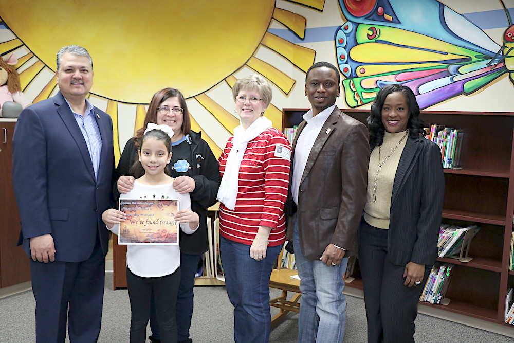 
Jannel Cruz (front), third grade, shows off the certificate for four Pirates Bay Tickets she received in a drawing at Bowie Elementary for reading 10 or more books for the Mayor’s Winter Break Challenge through the Renaissance myON Reader program. The individualized reading program was made possible through a grant from Covestro, the school’s Partner In Education.  Pictured are (from left) Baytown Mayor Brandon Capetillo; Claudia Ovalle, third-grade teacher; Donna Mohlman, community engagement specialist for Lee College; Councilman Charles Johnson and Dr. Regina Sims, Bowie principal.
