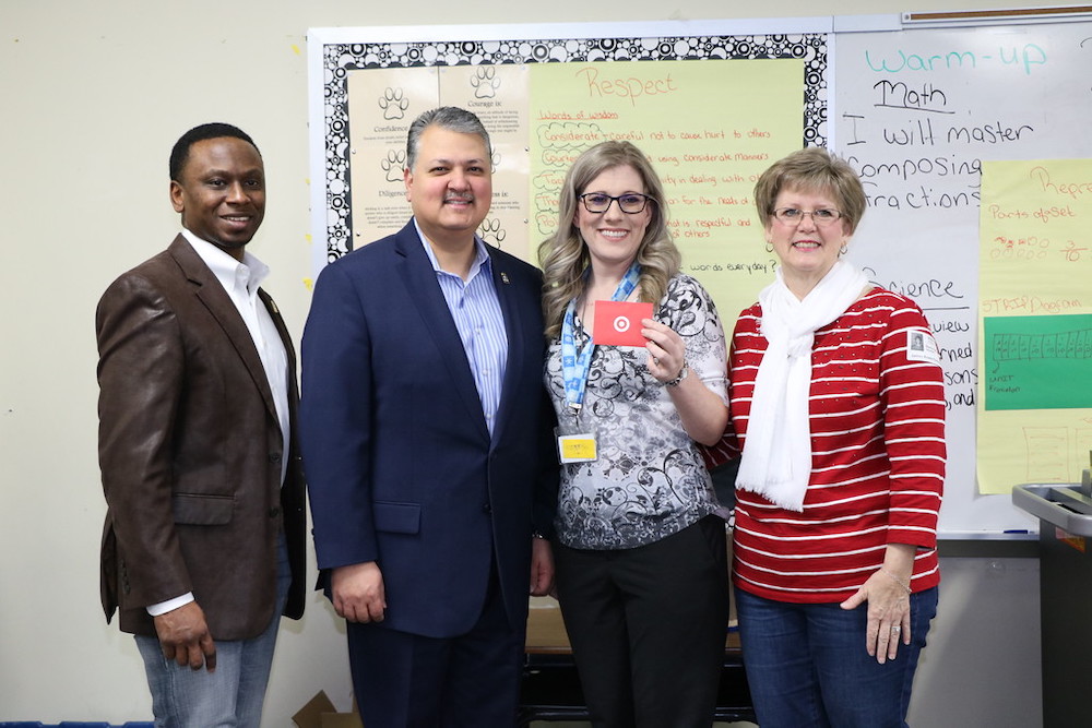 
August Benoit (second from right), a fourth-grade teacher at Bowie Elementary, receives a Target gift card from Donna Mohlman (right), community engagement specialist for Lee College. Since fourth-grade students read the most books through the Renaissance myON Reader program of any grade level during the Mayor’s Winter Break Challenge, their teachers’ names were entered in a drawing. Also surprising Benoit and her students in her classroom are Councilman Charles Johnson (left) and Mayor Brandon Capetillo.
