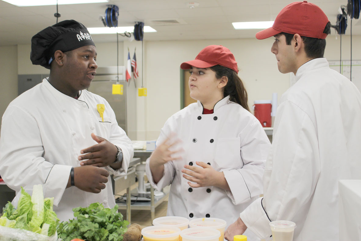 
Robert E. Lee High School students (from left) Favyon Russell, Kaitlyn Ruiz and Angel Palos work out some details during the recent Lone Star Chef Competition before preparing “Trash Can Nachos.” The team was coached by Chef Ginger Zoidis.
