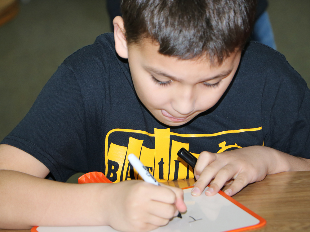 
Kaelob Schuelzky, a sixth-grader at Highlands Junior School, concentrates on the title of a book during the Battle of the Books held at Horace Mann Junior School. All five junior schools participated in the event.
