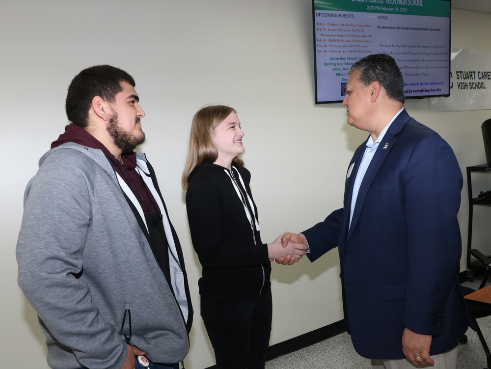 
Stuart Career Tech High School students Rick Reyes, 10th-grade, and Sierra McBride, ninth-grade, greet Mayor of Baytown Brandon Capetillo, who spoke to students about the City of Baytown and about the advantages of SCTHS in this area.
