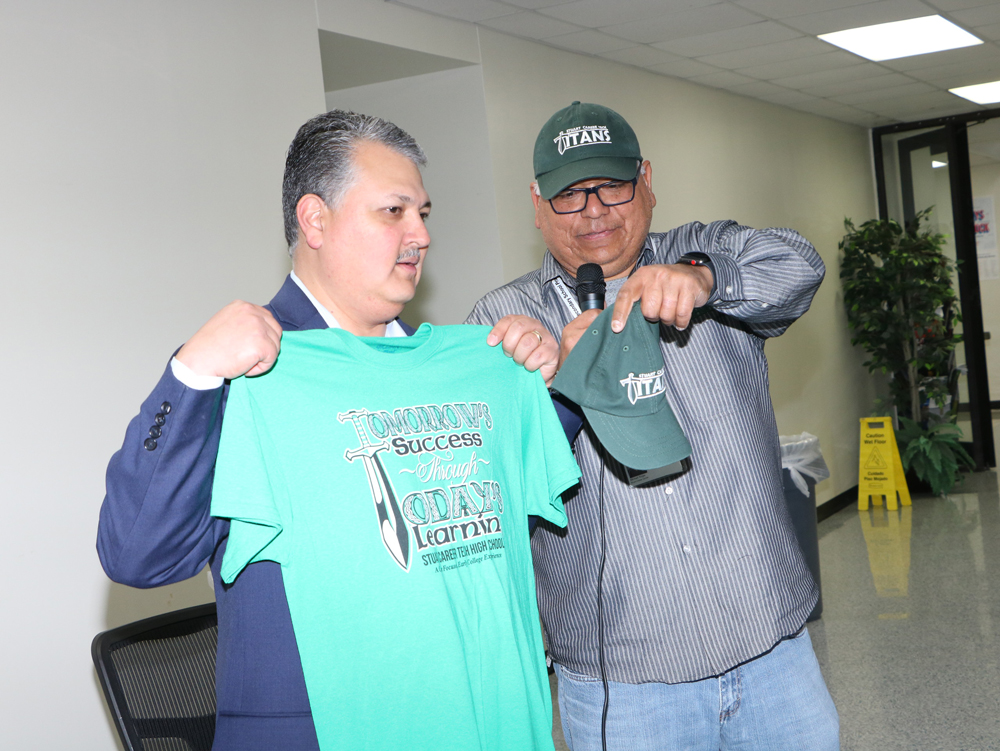 
Mike Riojas (right), assistant principal at Stuart Career Tech High School, presents a SCTHS t-shirt and hat to Baytown Mayor Brandon Capetillo, who spoke to students about the City of Baytown.
