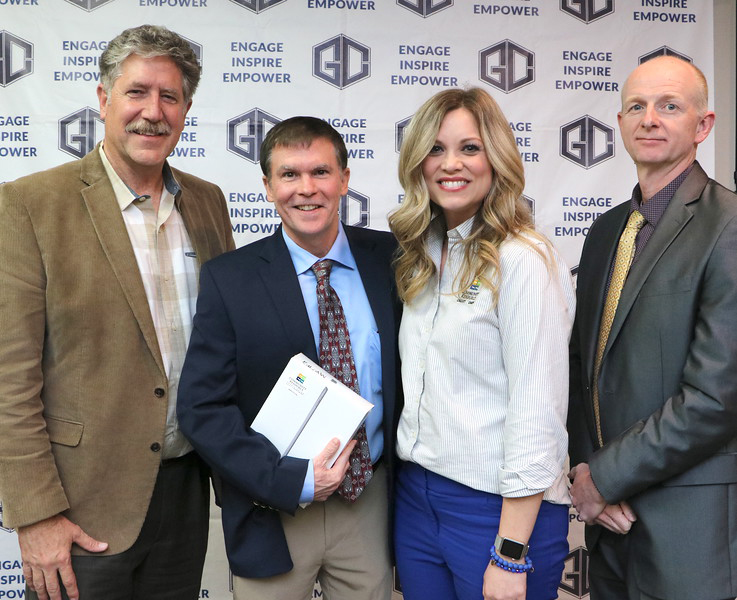 
Bart Cobb (second from left), principal of George Washington Carver Elementary and Elementary Principal of the Year for Goose Creek CISD, receives an iPad from Macie Schubert (second from right), business development manager for Community Resource Credit Union, at a recent meeting of the GCCISD board of trustees. Congratulating Cobb are Dr. Randal O’Brien (left), GCCISD superintendent, and Pete Pape (right), president of the GCCISD board of trustees.