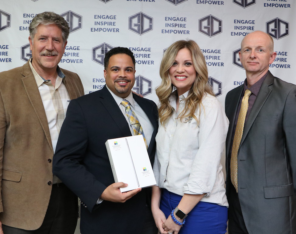 
Michael Curl (second from left), principal of Cedar Bayou Junior School and Secondary Principal of the Year for Goose Creek CISD, accepts an iPad from Macie Schubert (second from right), business development manager for Community Resource Credit Union, at a recent meeting of the GCCISD board of trustees. Dr. Randal O’Brien (left), GCCISD superintendent, and Pete Pape (right), president of the GCCISD board of trustees, congratulate Curl.
