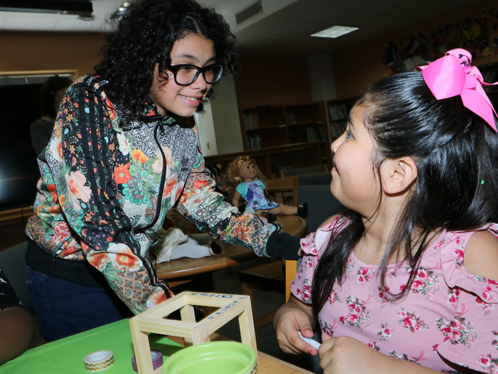 
Evelynn Cardenas and Giselle Del Toro work on crafts at the Dolls4All tea party at Ashbel Smith Elementary.
