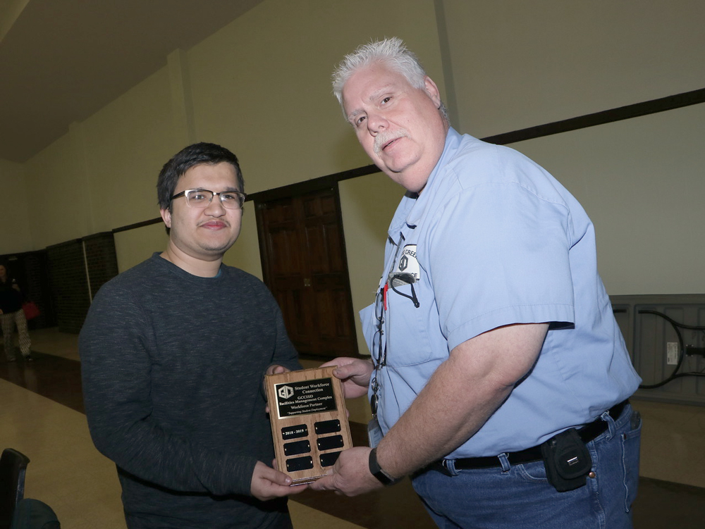 
James Polvadore (right), Goose Creek CISD Warehouse foreman, and student employee Anthony Villarreal from Goose Creek Memorial High School, display the plaque Polvadore received at the recent Student Workforce Connection Employer Appreciation Luncheon.
