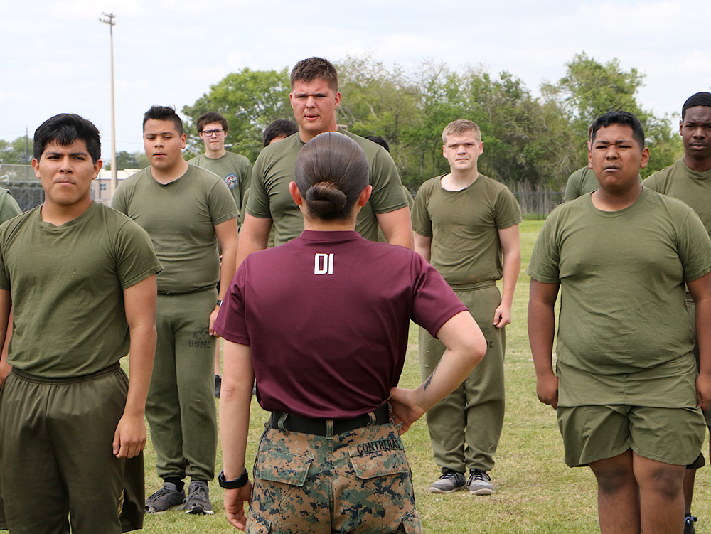 
SSgt Michelle Contreras (front), a Marine from California who has been deployed all over the Middle East, takes Ross S. Sterling High School MCJROTC cadets through some of the Daily 17, a routine of exercises recruits perform at boot camp. Pictured are (from left) Angel Alvarado, Gustavo Hernandez, Cameron Berwick, Trace Smoke, Justyn Putnam, Giovanni Deleon and Raheem Charmon.
