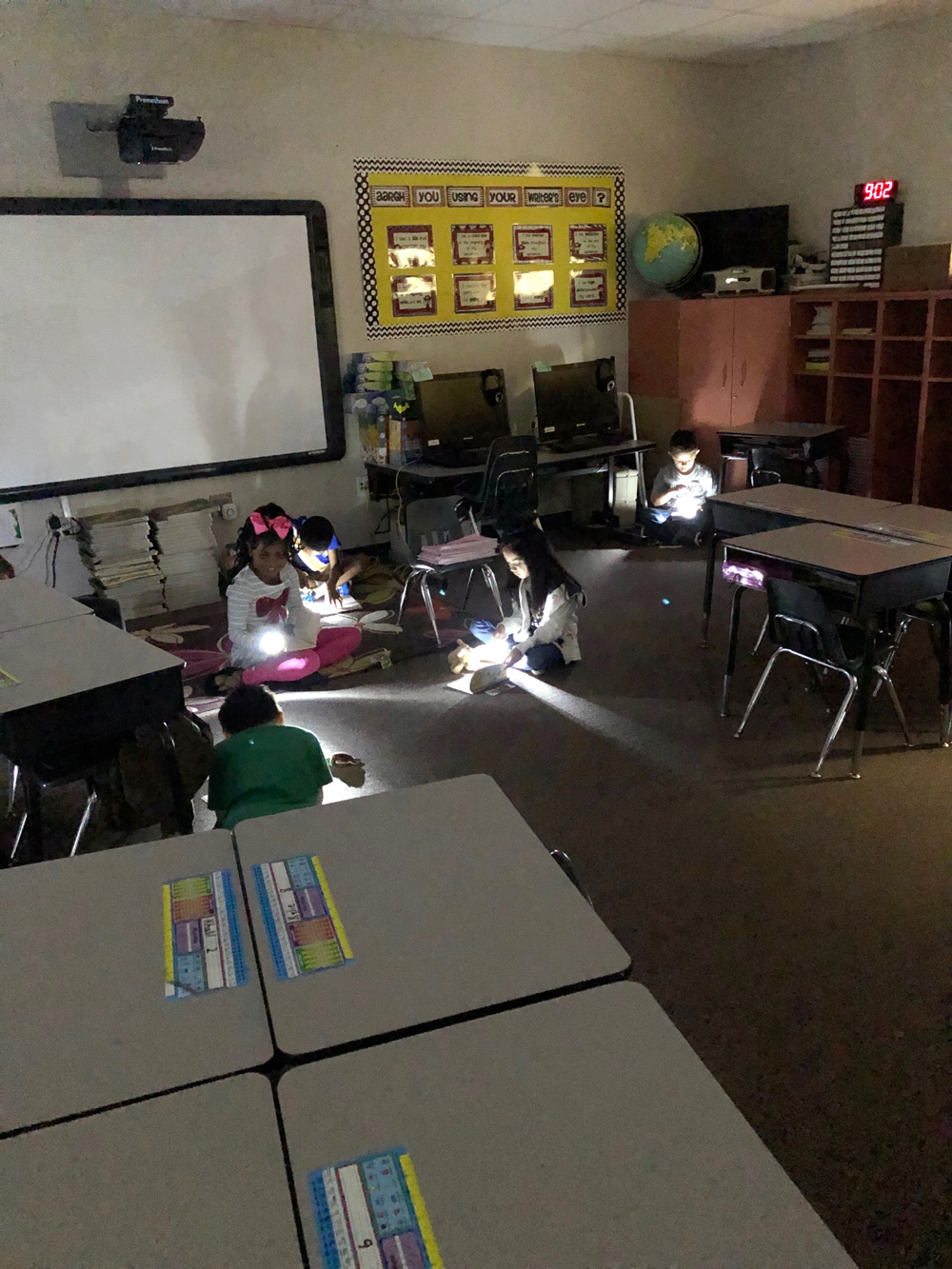
Melissa Lindsey’s first-grade class at Travis Elementary celebrates Flashlight Friday by reading their chapter books by flashlight. Pictured are (from left) London Johnson, Audrina Mireles, Khalil Favrier and Jack Pettine.
