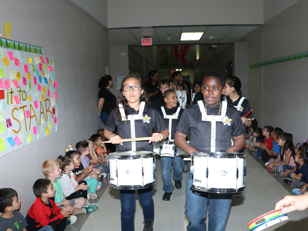 
Naveah Hernandez (left) & Makhai Jones from the Carver Elementary drumline parade through Austin Elementary with the Goose Creek CISD Education Foundation’s Grant Surprise Patrol to give out innovative teaching grants.
