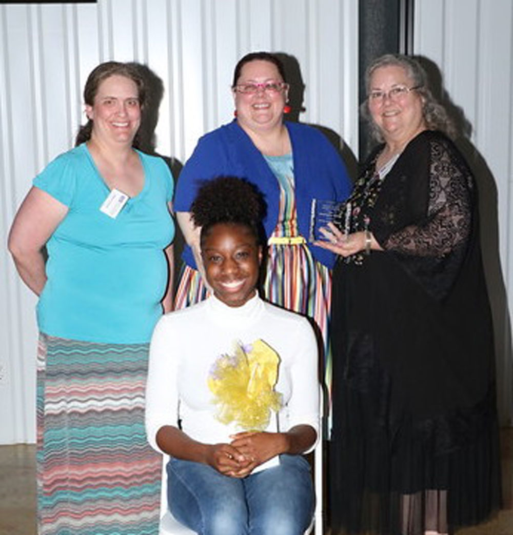 
Josiah Hughes (front) from IMPACT Early College High School, honors her former teacher Patricia Authement (back right) from Gentry Junior School. Megan Downs (back left) from Cedar Bayou Junior School was also honored by student Everett Crutchfield (not pictured) from IMPACT ECHS. Also pictured is Emily Patrick, English teacher, from IMPACT ECHS.
