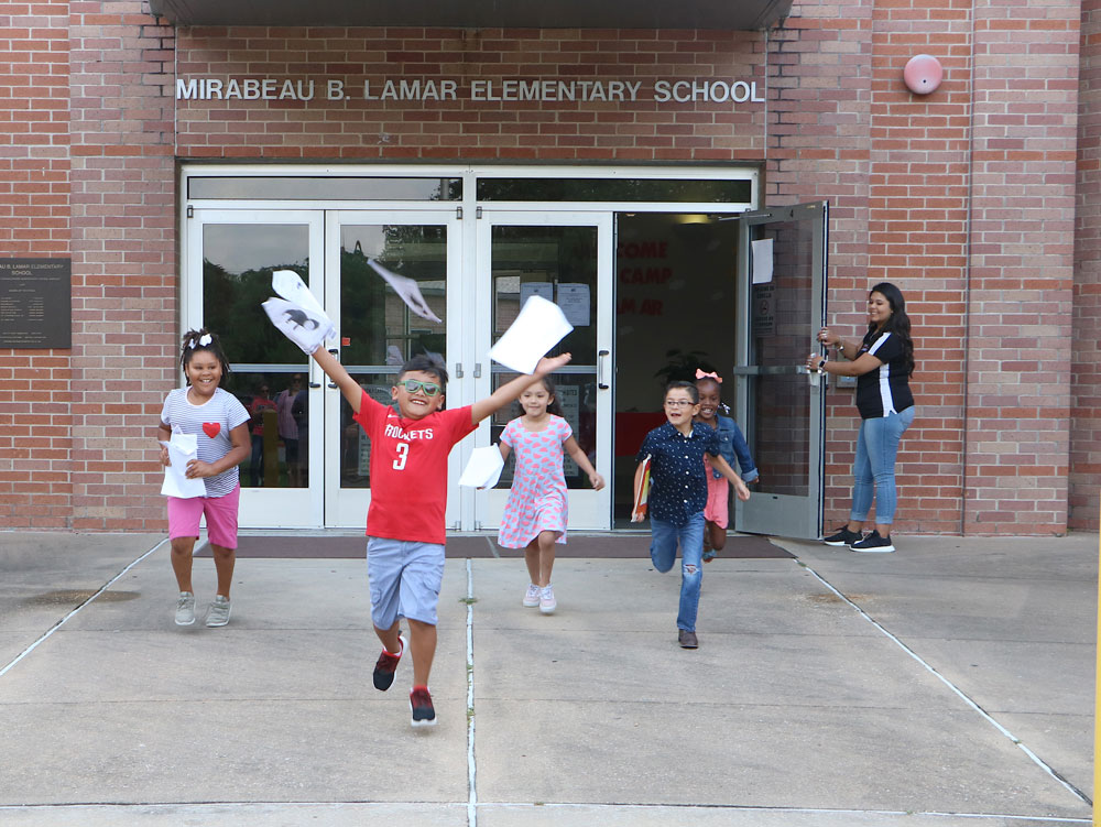 
Lamar Elementary students (from left) Kristopher Soto, Kort’lynn Kindle, Janessa Torres, Elijah Valencia and Taylor Green run out of school on the last day, ready to enjoy the summer break!
