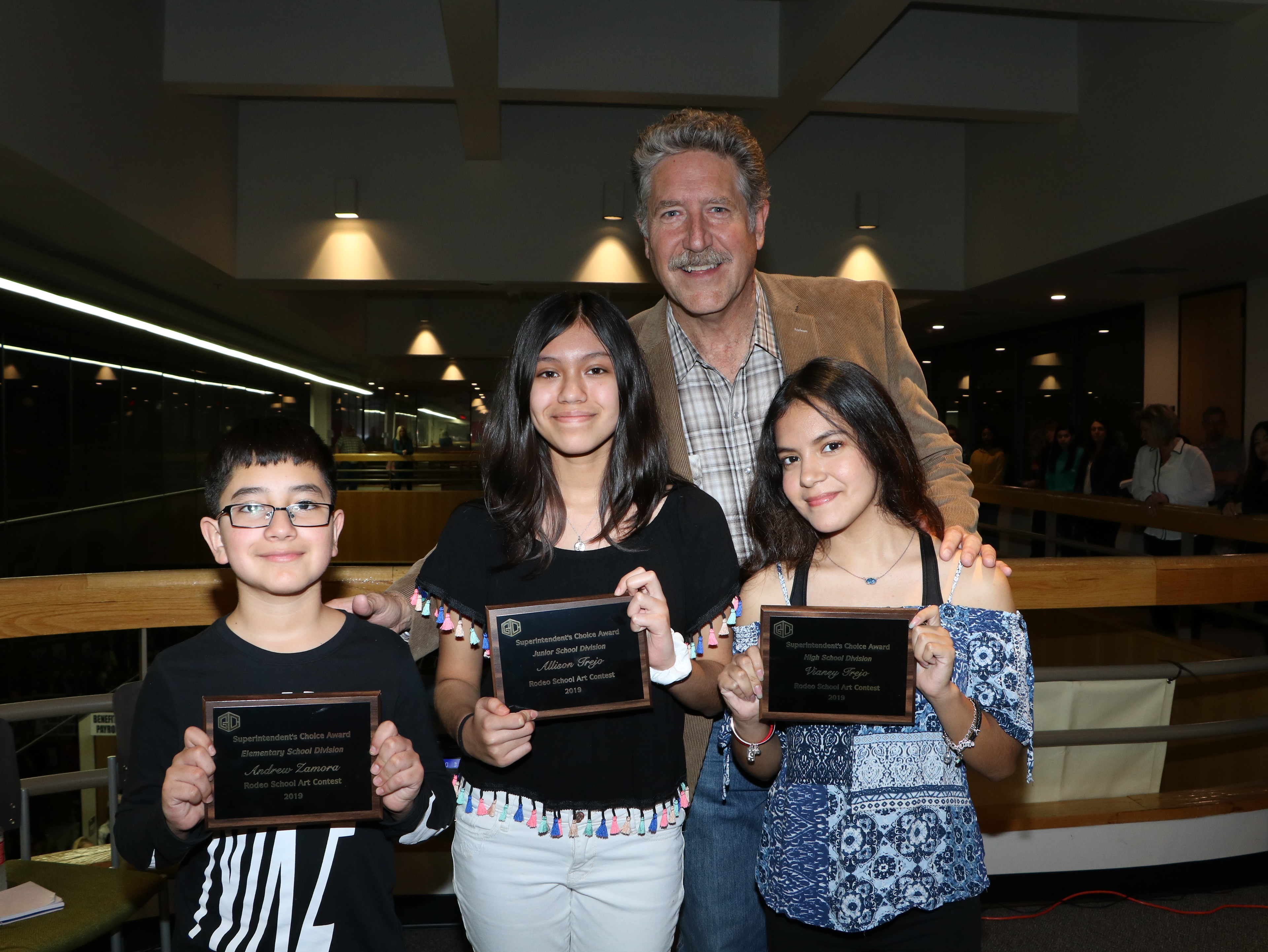 
The Superintendent’s Choice Awards from Goose Creek CISD’s Rodeo Art are (from left)  Elementary: Andrew Zamora, fifth-grader at Clark Elementary, with “The Old Tractor;” Molly Barr, art teacher; Junior School: Allison Trejo, eight-grader at Gentry Junior, with “What’s for Dinner?” Jennifer Martin, art teacher and High School: Vianey Trejo, 10th-grader at Goose Creek Memorial, with “Praying on a Summer Day,” Johanna Morris, art teacher. They are pictured with Dr. Randal O’Brien, GCCISD superintendent.
