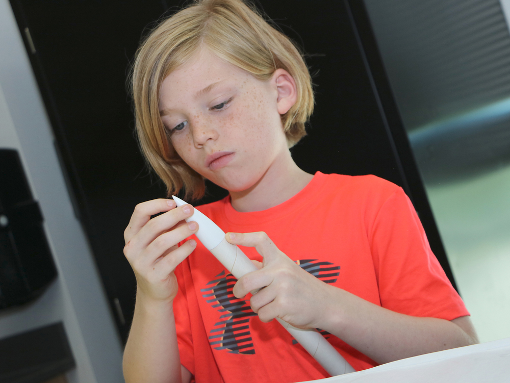 
Hudson Bernard from Austin Elementary makes sure the tip of the rocket she is creating at Goose Creek CISD’s Rocketeer Camp is in place.
