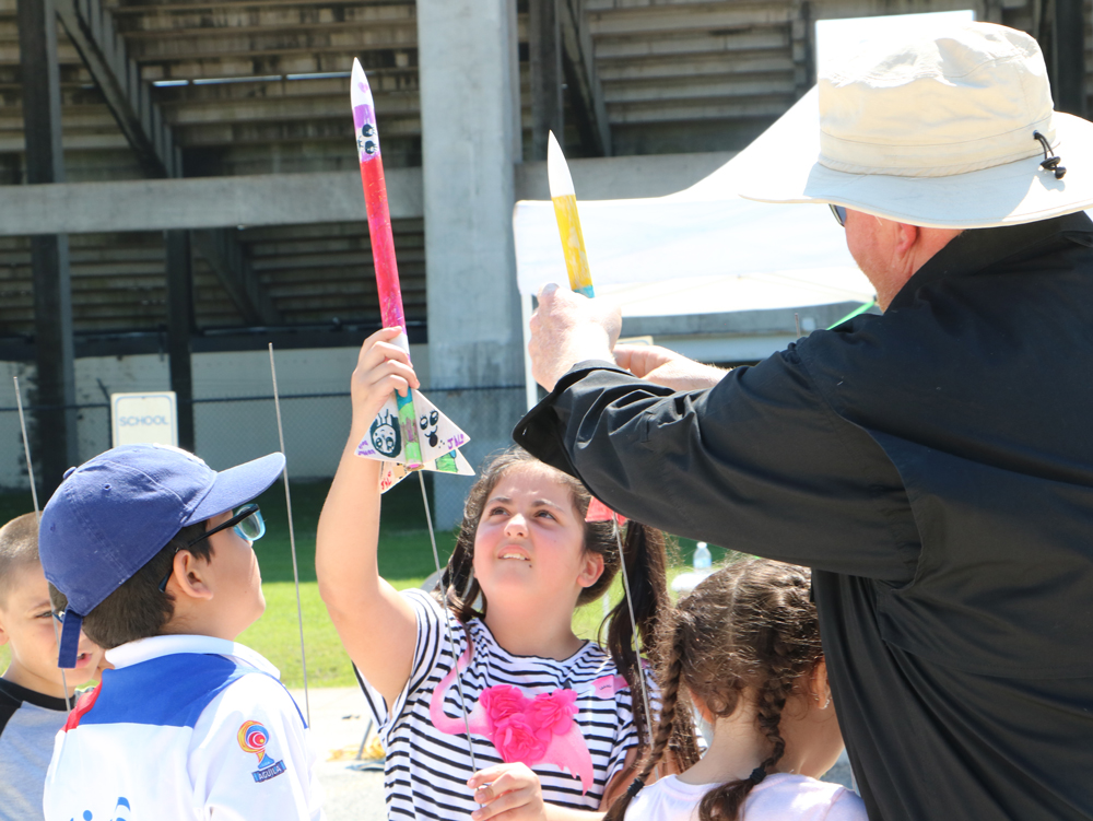
Leah Clifford (middle) and Ricky Moore, instructor, set rockets up on the launch pad as they prepare to see the results of their work at Goose Creek CISD’s Rocketeer Camp.
