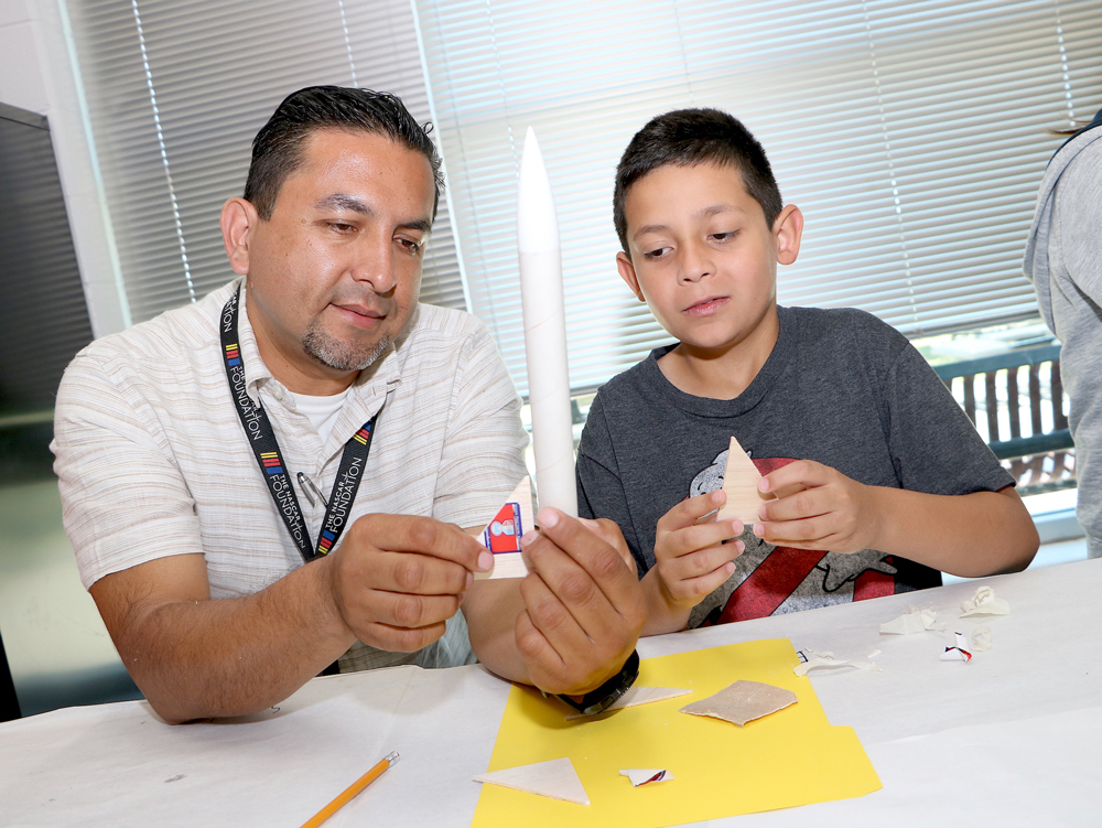 
Guillermo Najera (left), a teacher at Ashbel Smith Elementary, helps Ethan Juarez, a student at Stephen F. Austin Elementary create his rocket at Goose Creek CISD’s Rocketeer Camp.
