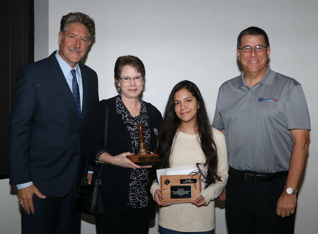  Vianey Trejo, 8th-grader from Highlands Junior School, is recognized as a Houston Livestock Show and Rodeo School Art winner at a recent GCCISD board meeting and congratulated by Randal O’Brien (left), Goose Creek CISD superintendent, and
Al Richard (right, Goose Creek CISD board president. She is under the direction of art teacher Carla Griffin, who received a School Bell Award. 